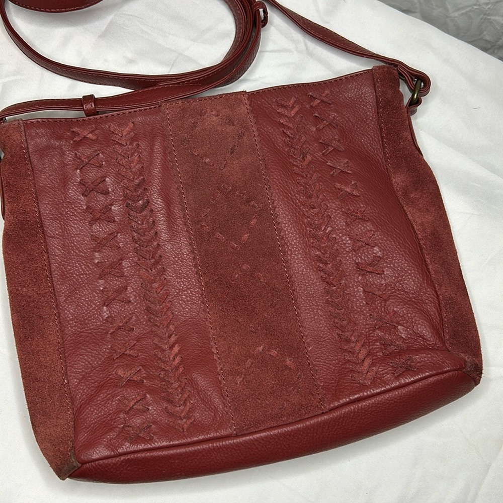 SERRV red suede/leather crossbody. Leather braided design on front.